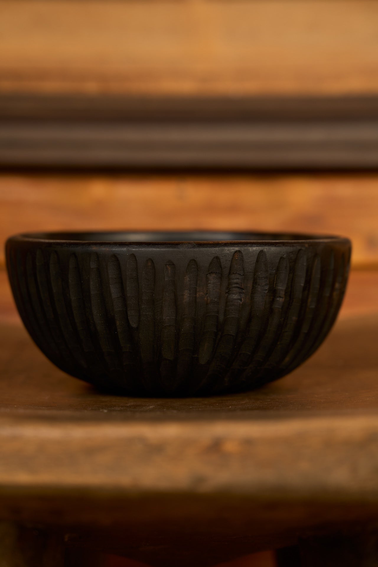 Black decorative bowl on a wooden surface