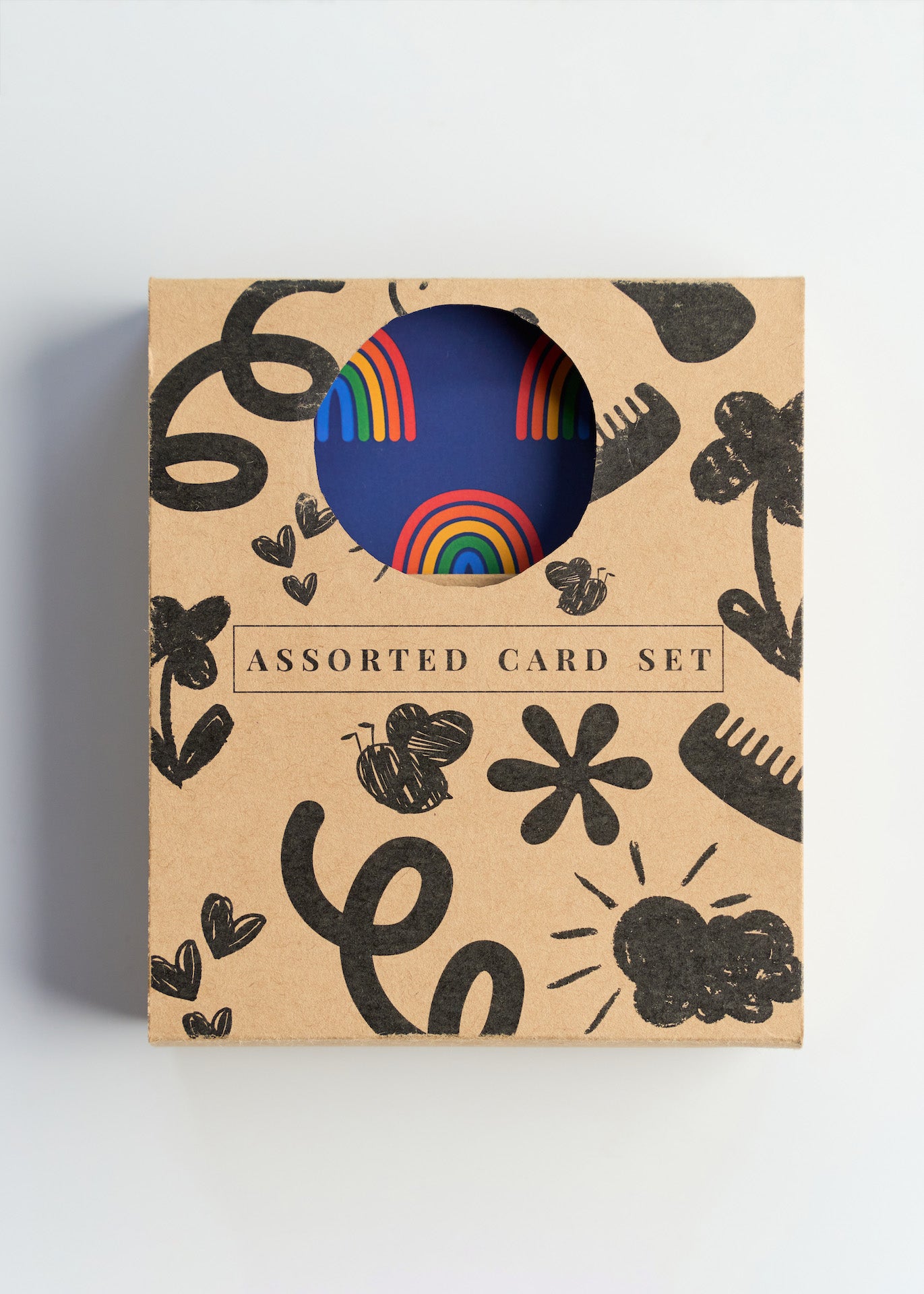 Assorted card set packaging with rainbow design on a light gray background