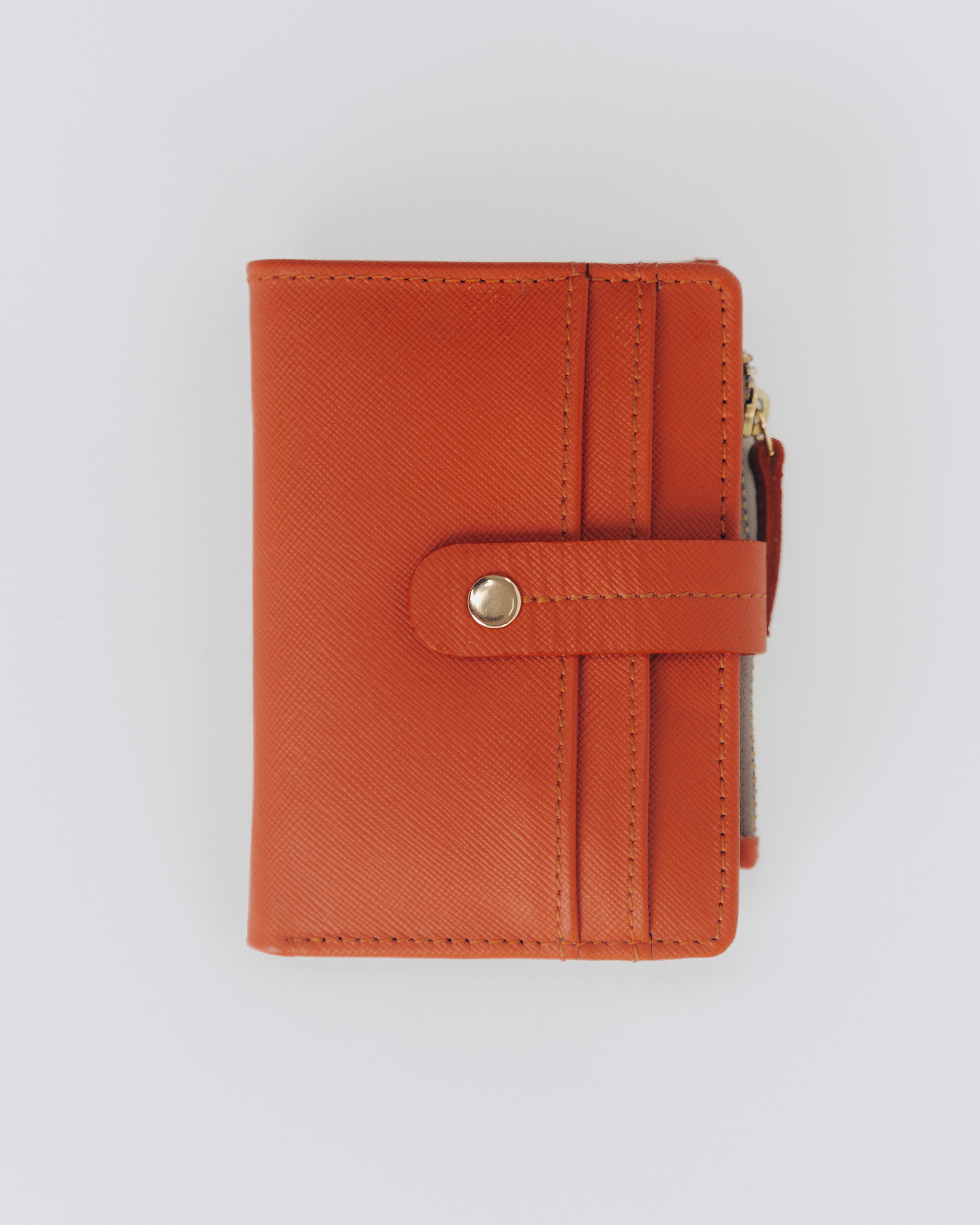 Orange leather compact wallet close up of Card slots.