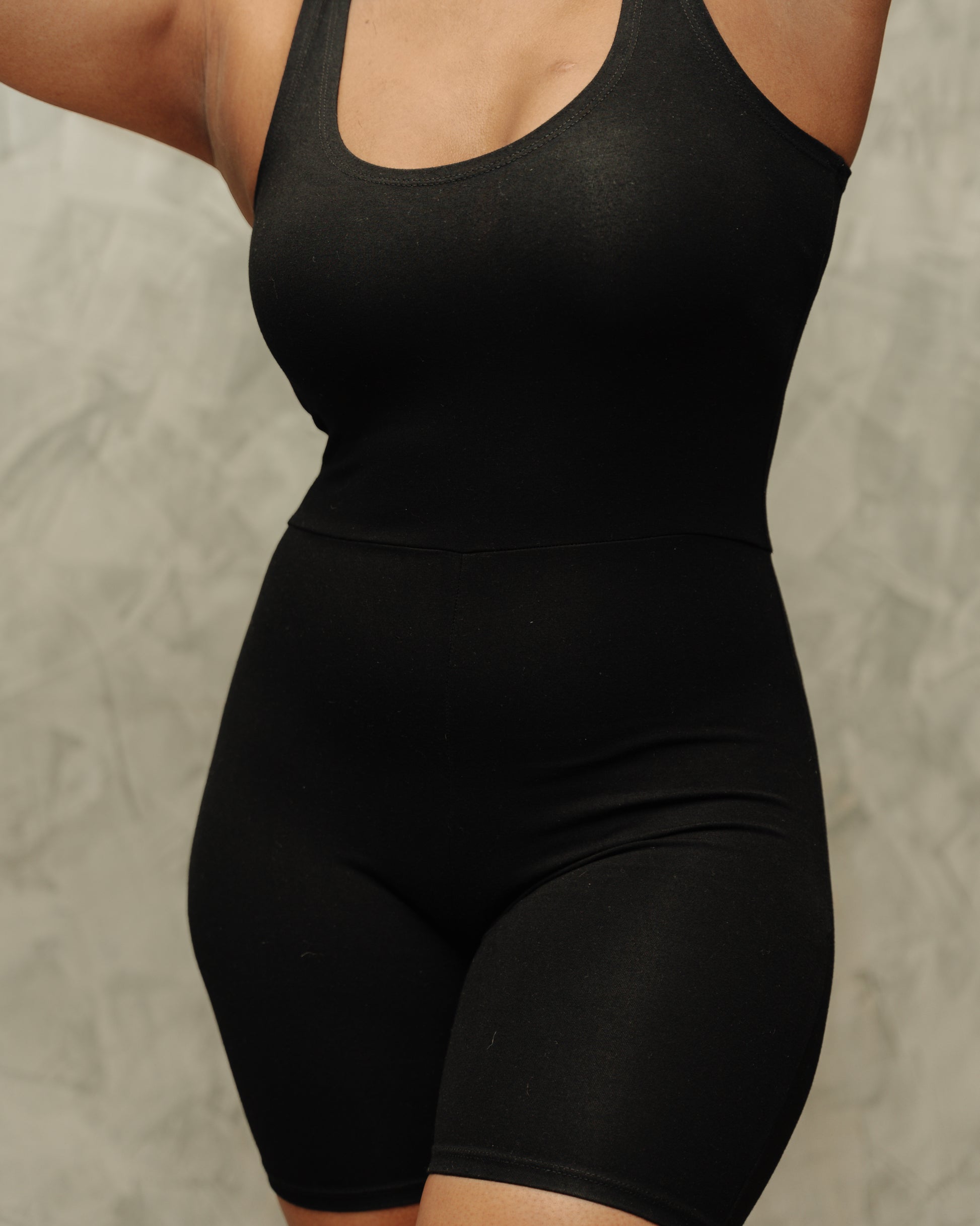 Short navy unitard worn on model