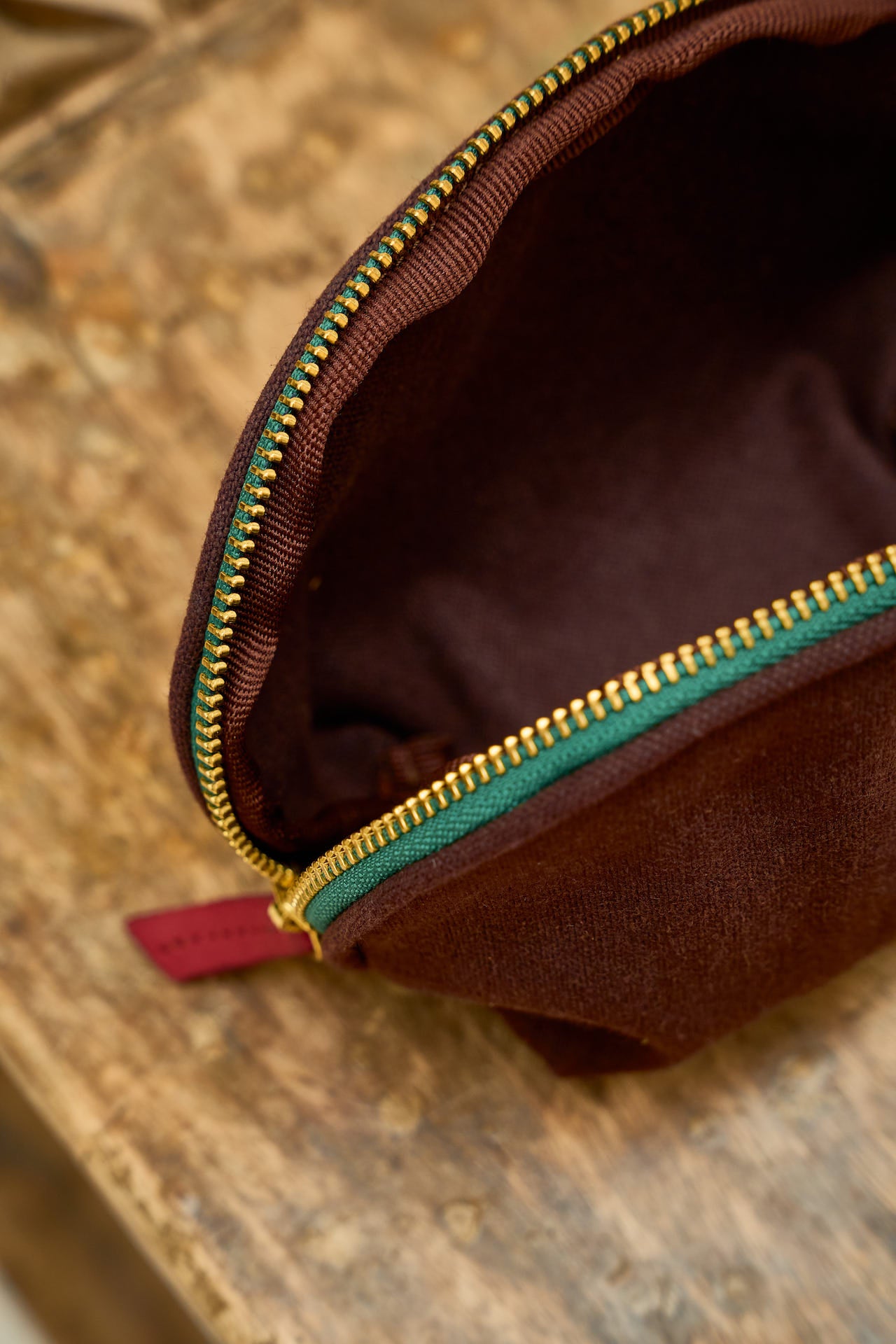 Brown pouch with gold zipper.
