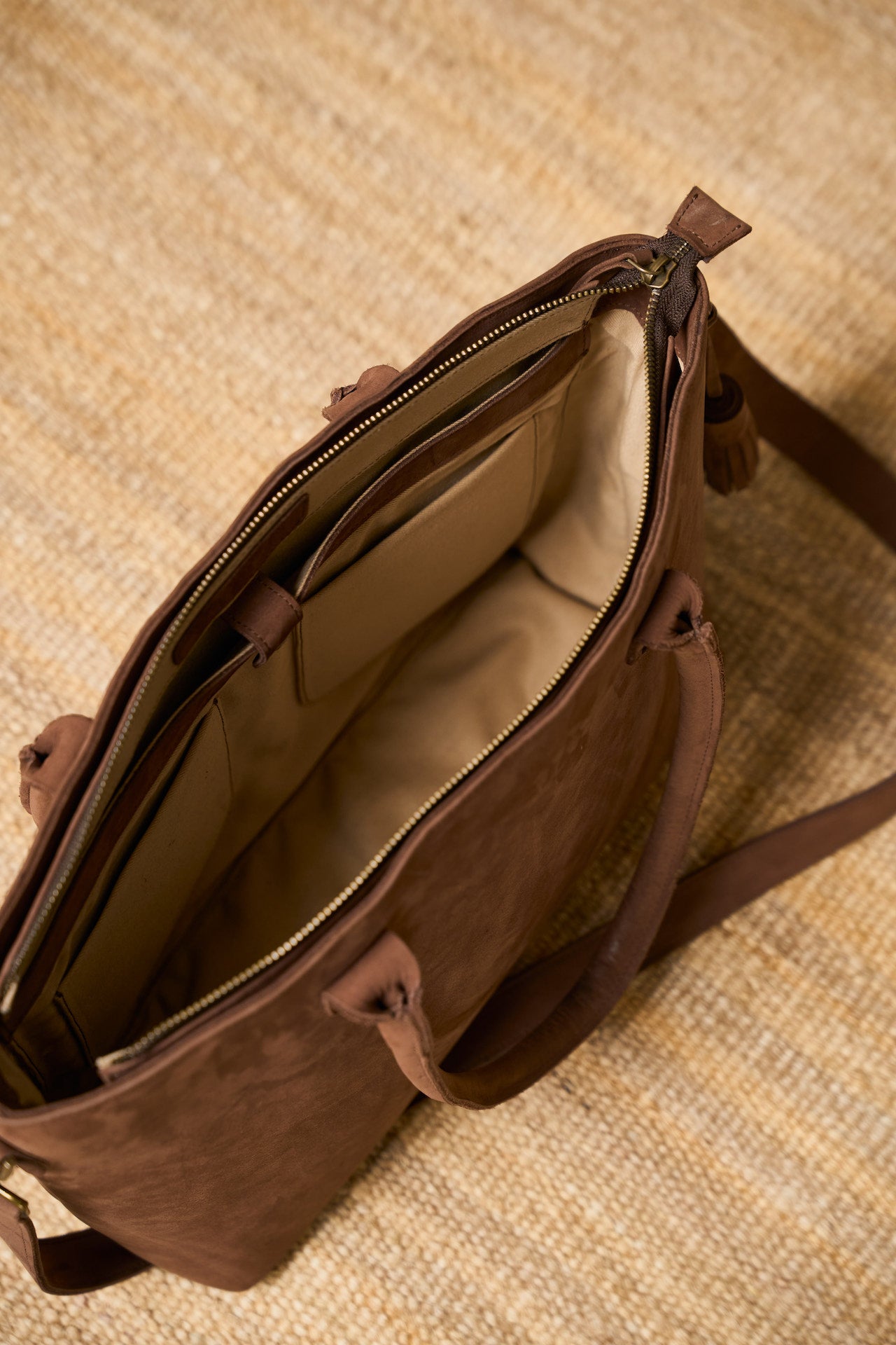 Brown suede  leather tote bag with open front pocket.