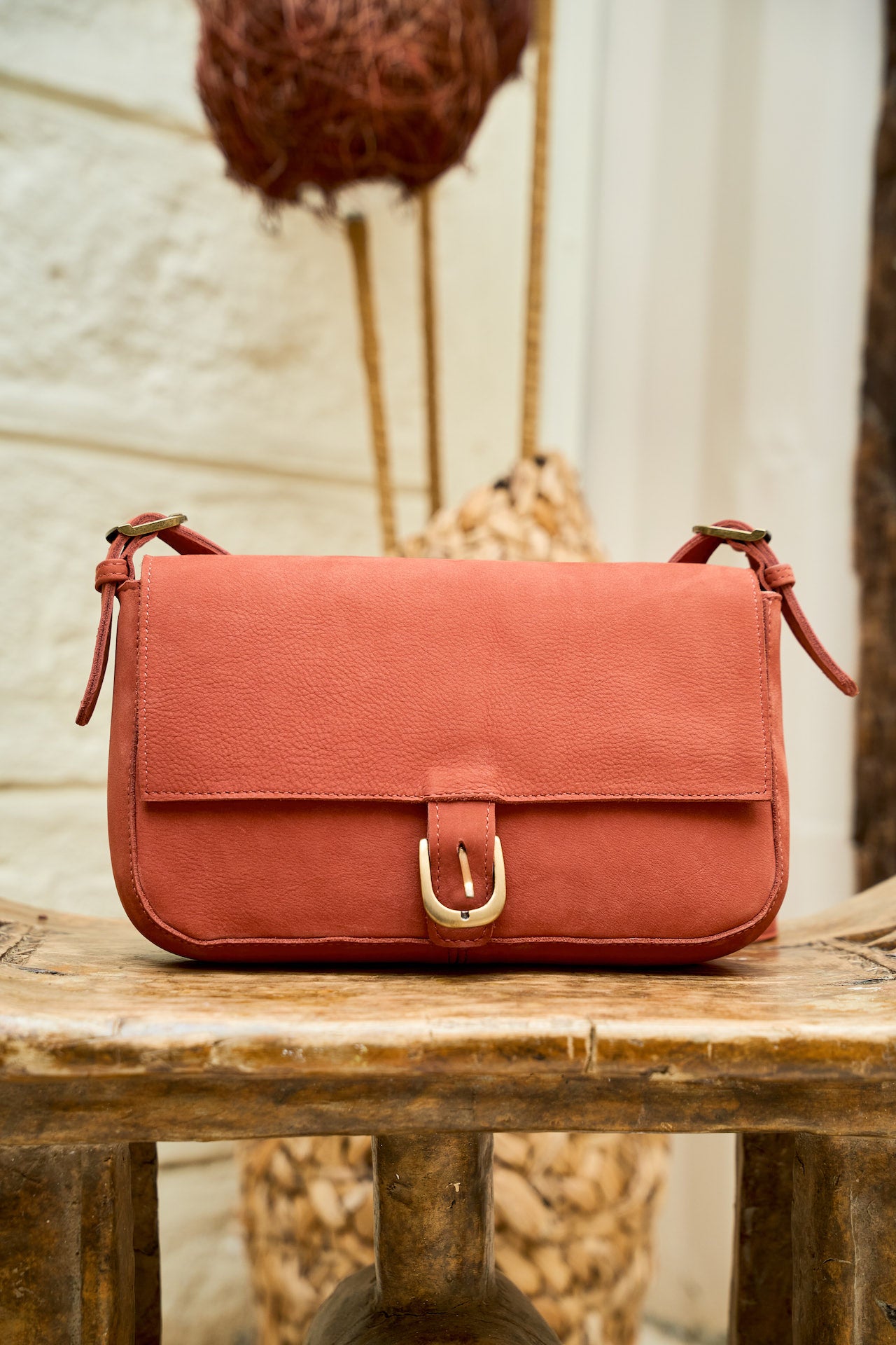 Manda suede handbag in fire brick Red, front view with a Gold buckle
