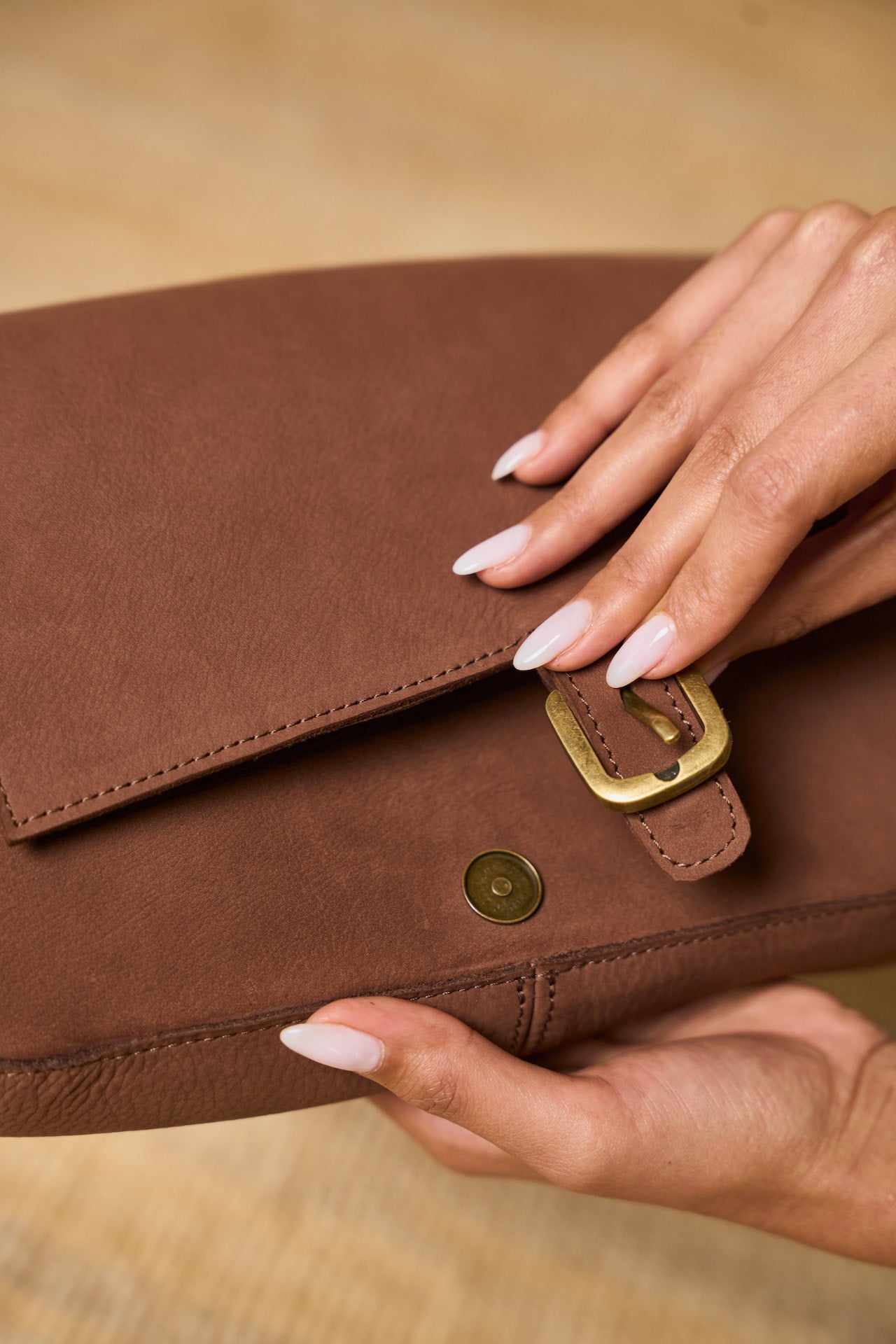 Manda suede handbag flap closure detail