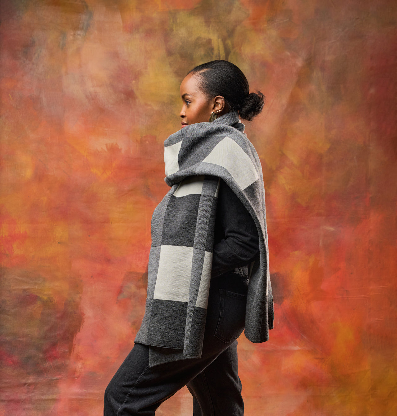 Woman wearing a gray and white checkered scarf styled for cold weather