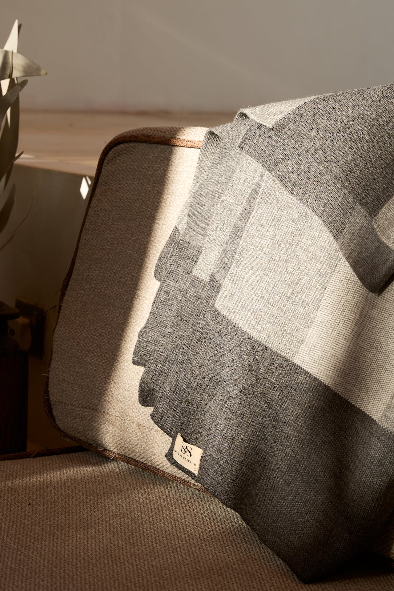 Gray checkered blanket draped over a chair as decor