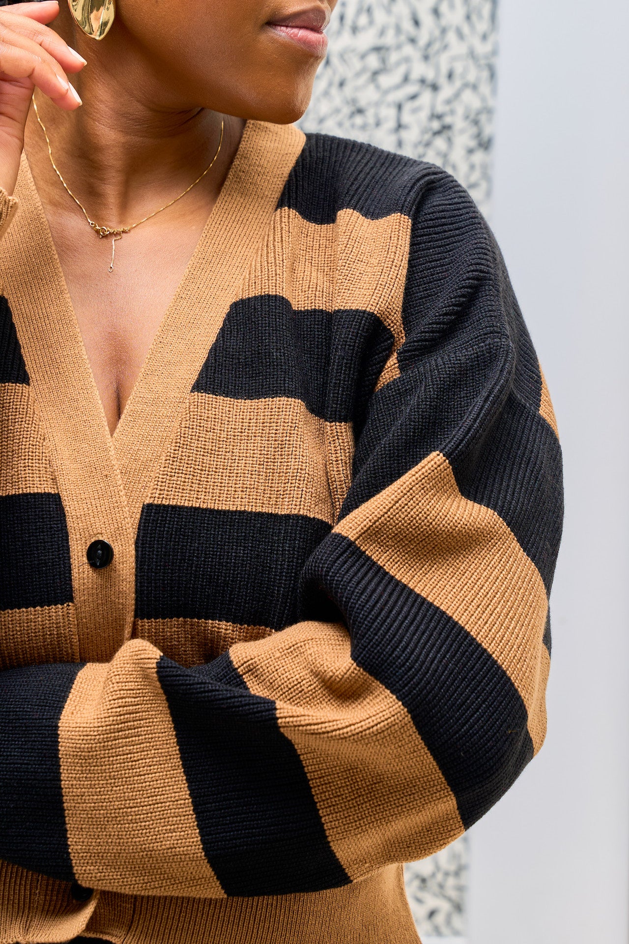 Black and brown Cropped cardigan V-neck detail.
