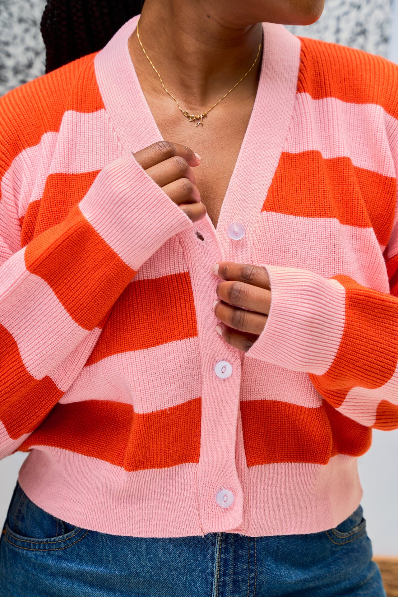 Pink and orange knit cropped cardigan v-neck detail.