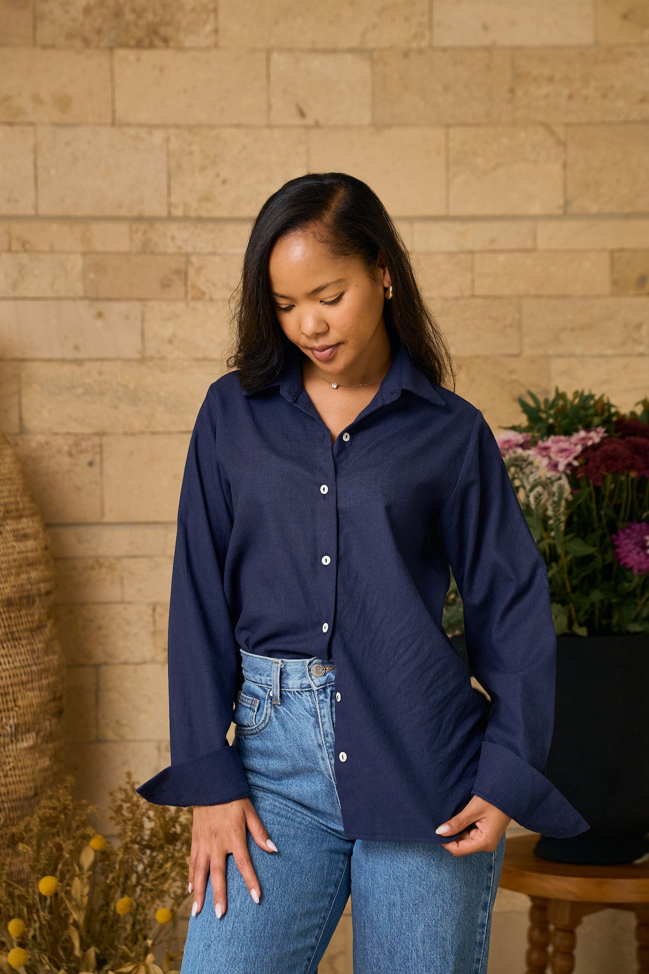 Woman wearing a navy blue Linen shirt styled with blue jeans 