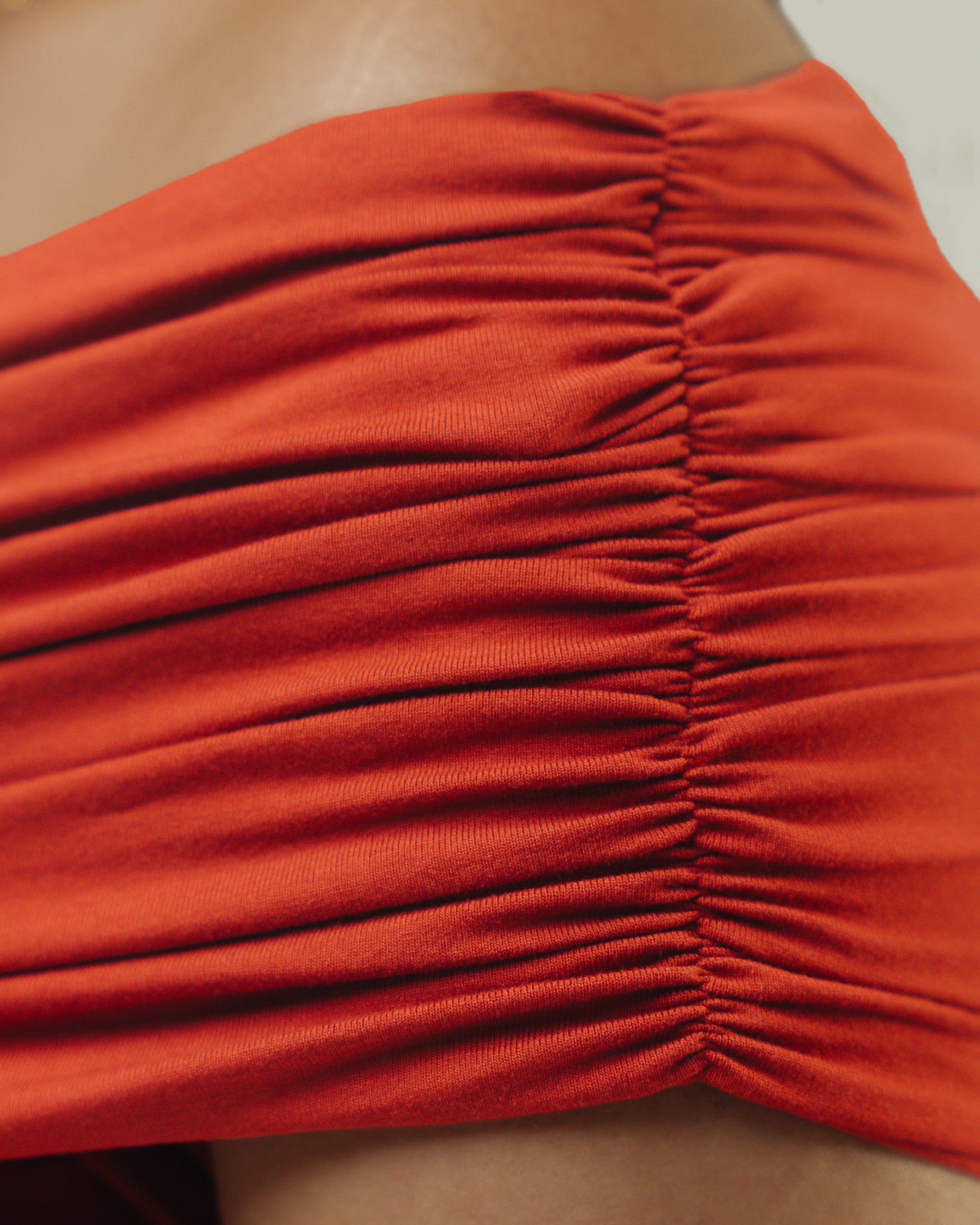 Close up of ruched bodysuit shoulder detail
