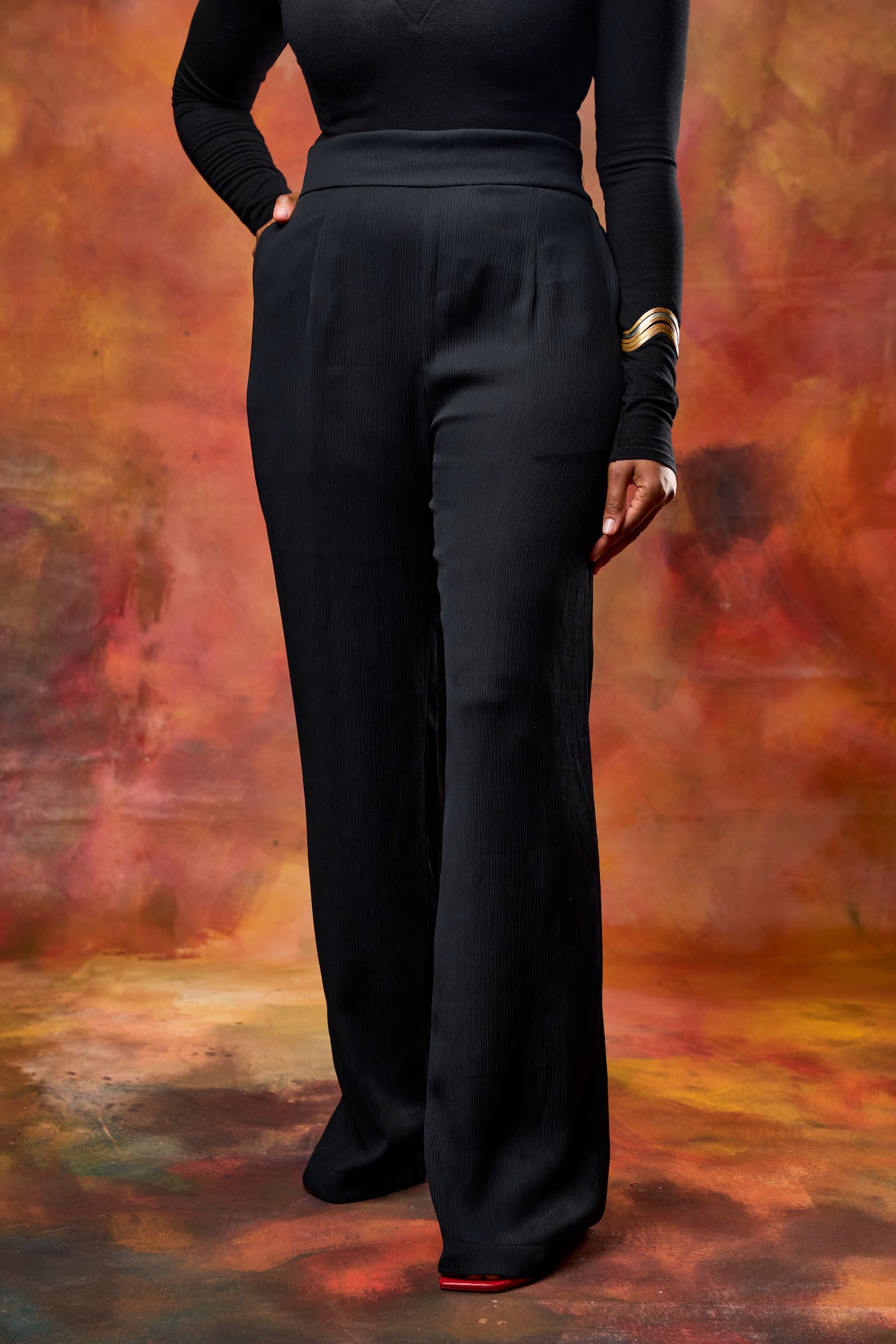 Woman wearing high-waisted wide leg pants from This Is Essential Kenya.