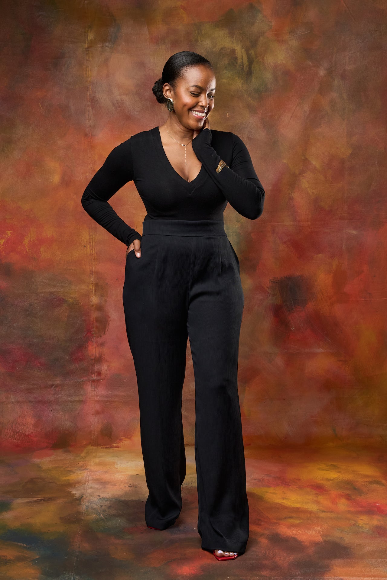 Front view of Woman wearing high-waisted wide leg pants from This Is Essential Kenya.