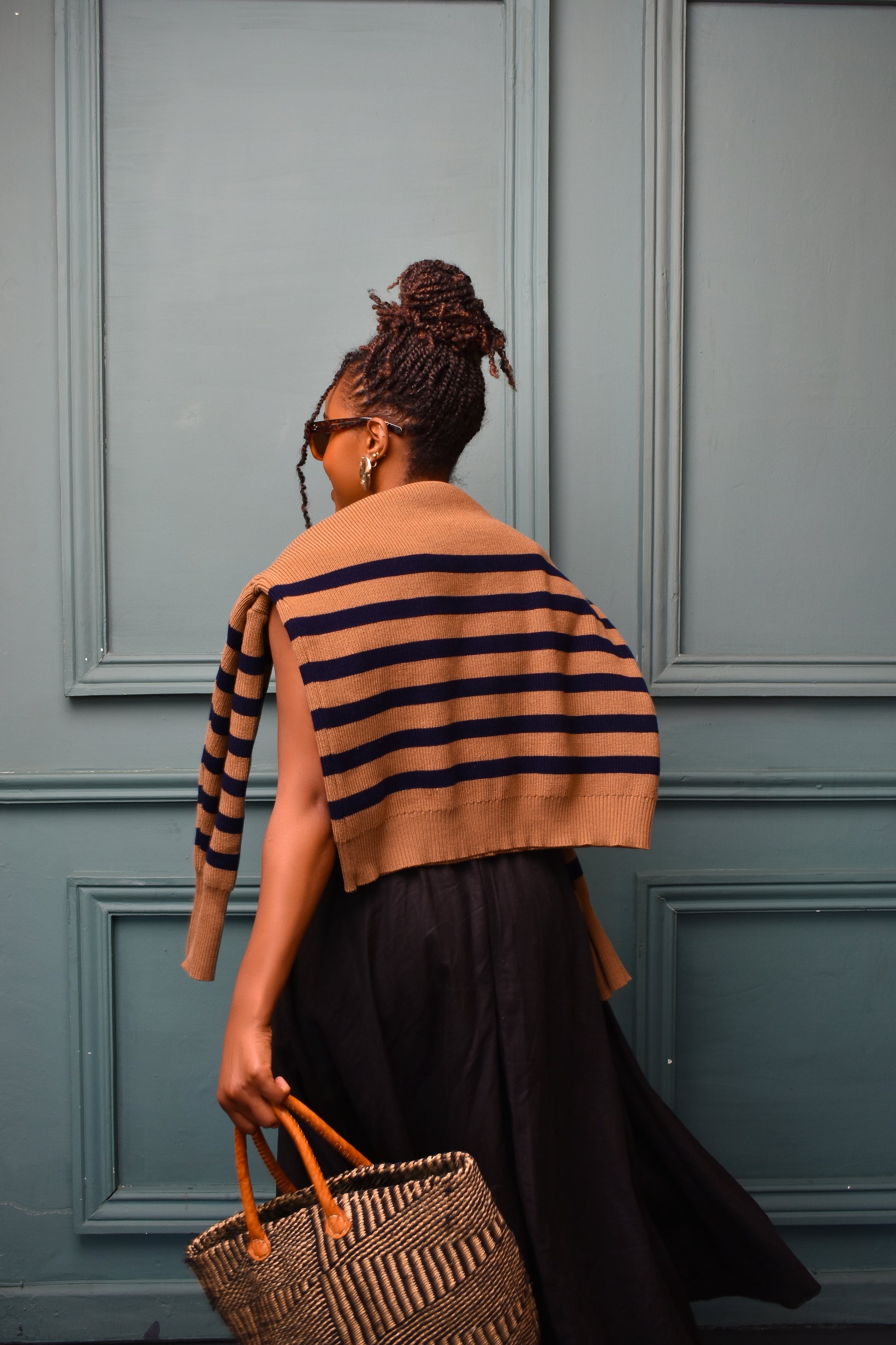 Toffee Knit striped sweater thrown casually on shoulders