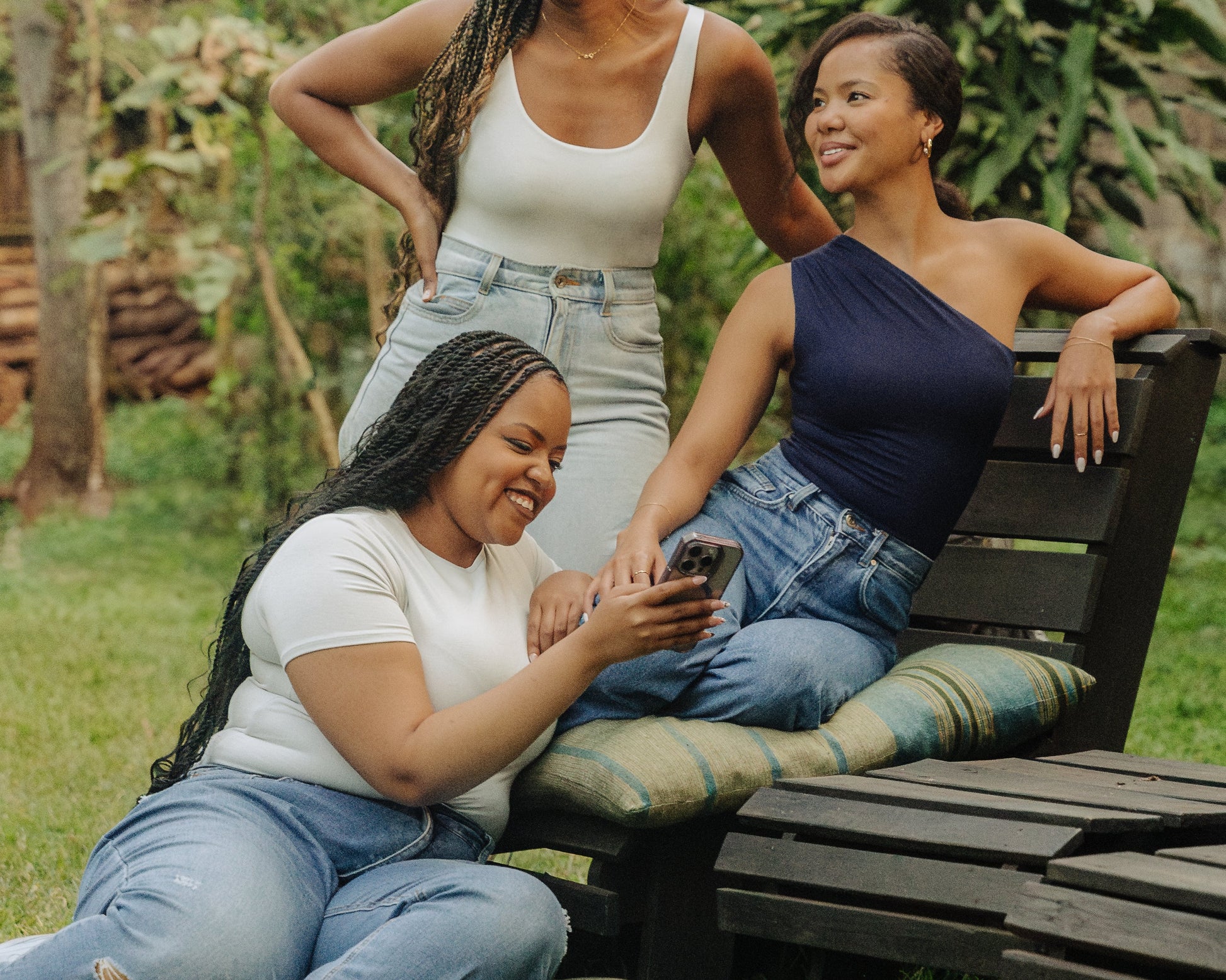 three women in grey scoop neck bodysuit, grey short sleeve bodysuit and one shoulder navy bodysuit.