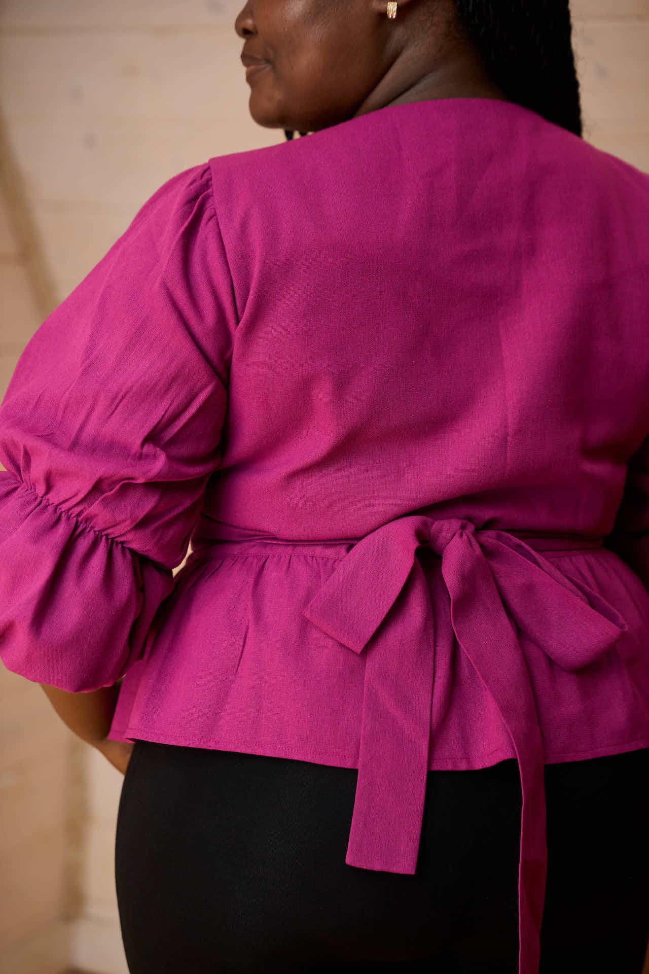 Yana linen blend wrap top in Magenta Back tie detail.