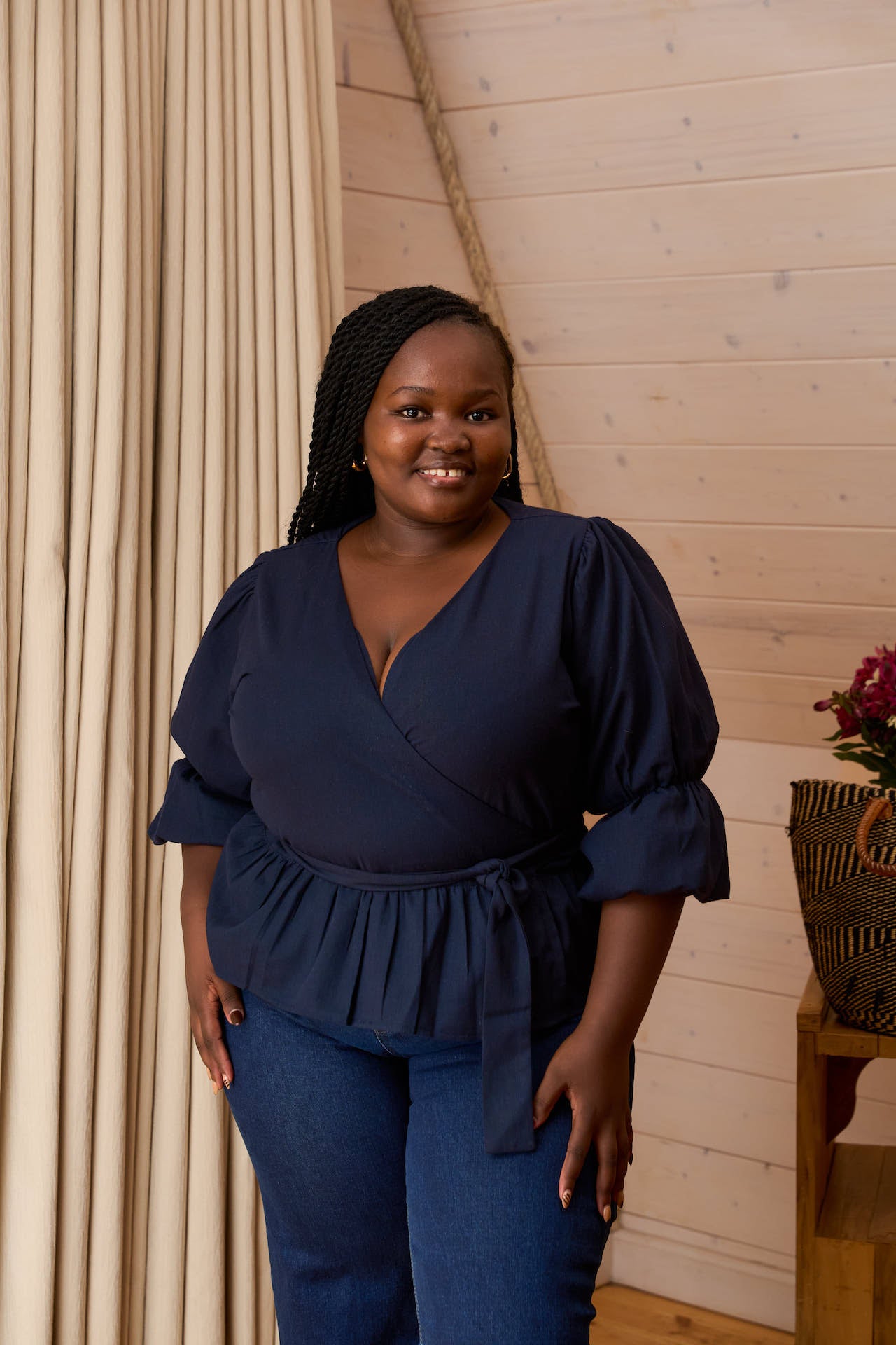  Plus size Woman in a navy blue Linen wrap top.