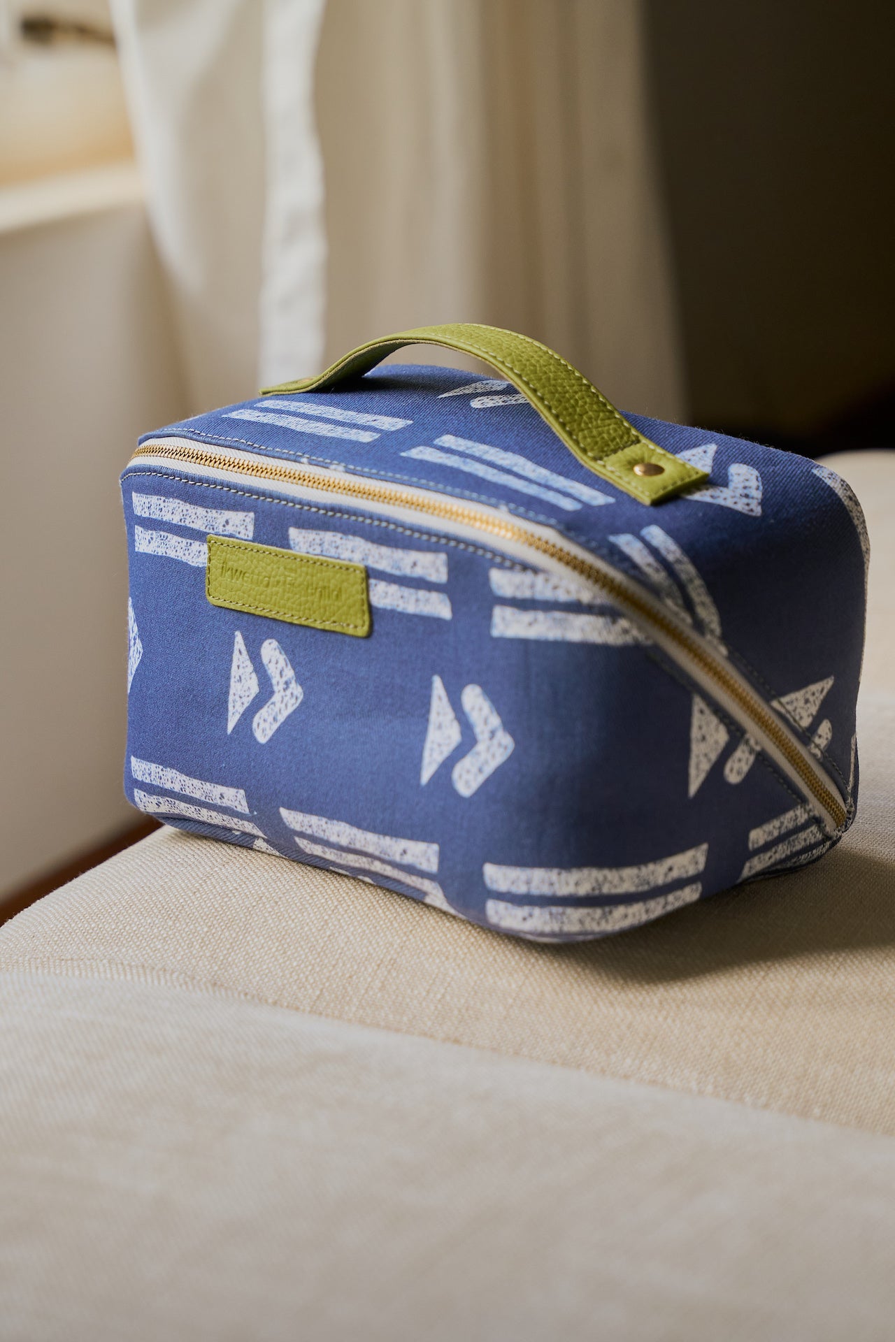 Blue toiletry bag in mudcloth print, front view